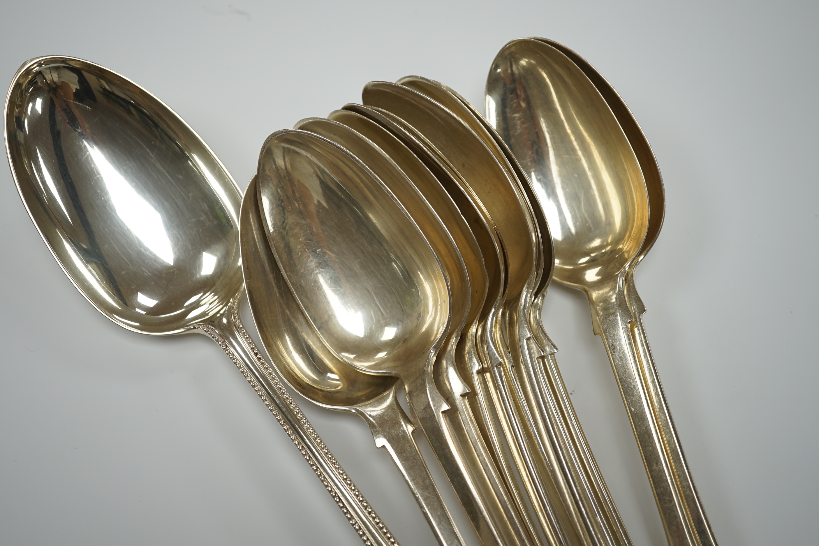 A Victorian silver beaded Old English pattern basting spoon by George Adams, London, 1872 and a small quantity of assorted 19th century silver fiddle pattern tablespoons, various dates and makers, 34.6oz.